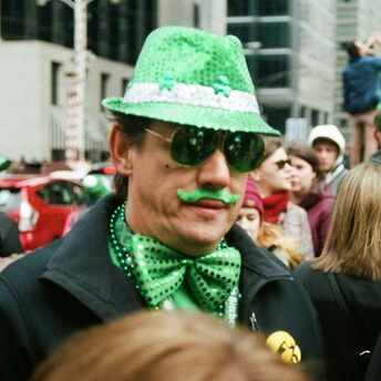 Person dressed in green during St Patrick’s Day street celebration