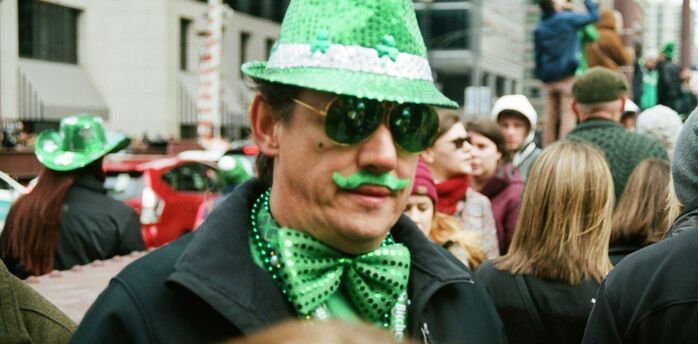 Person dressed in green during St Patrick’s Day street celebration