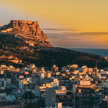 Alicante skyline with Santa Bárbara Castle above the city at sunset