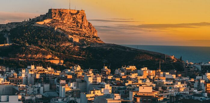 Alicante skyline with Santa Bárbara Castle above the city at sunset
