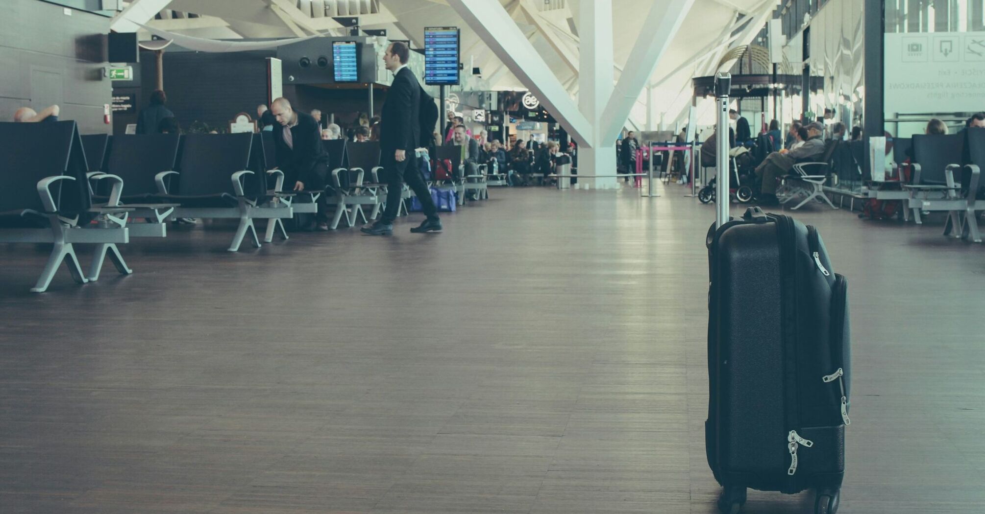 Single suitcase standing in airport departure hall