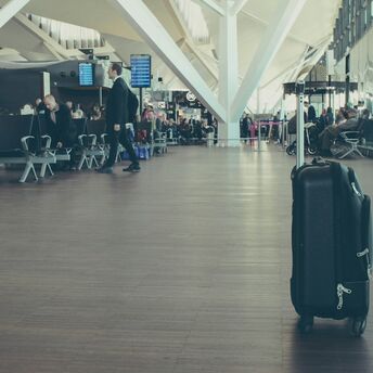 Single suitcase standing in airport departure hall
