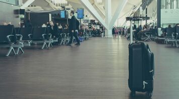 Single suitcase standing in airport departure hall