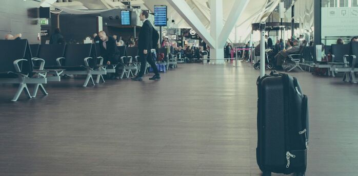Single suitcase standing in airport departure hall