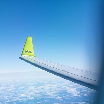 airBaltic aircraft wing with airline logo during flight