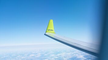 airBaltic aircraft wing with airline logo during flight