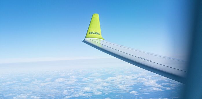 airBaltic aircraft wing with airline logo during flight