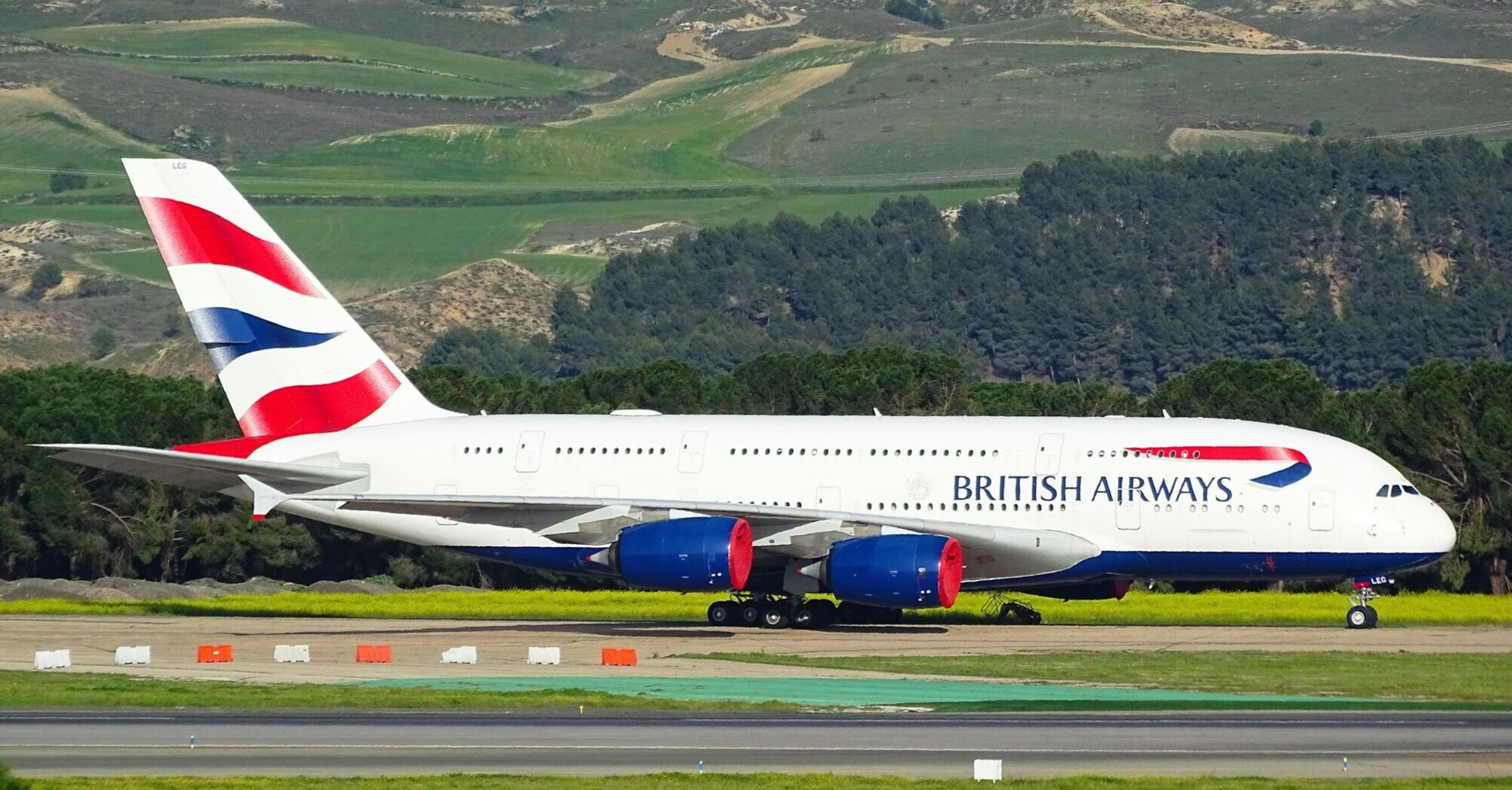 British Airways aircraft taxiing on runway during daytime operations