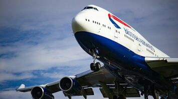 British Airways aircraft in flight with landing gear extended