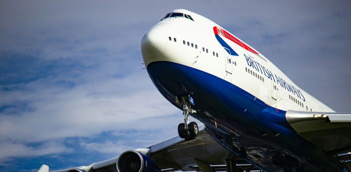 British Airways aircraft in flight with landing gear extended