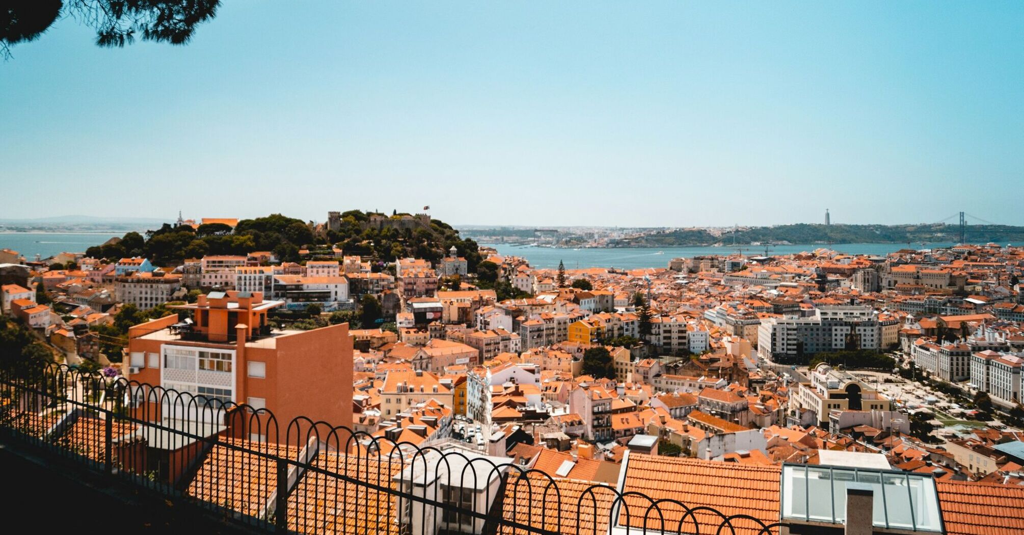Lisbon city skyline with river and historic rooftops