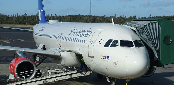 Scandinavian Airlines aircraft parked at gate during turnaround