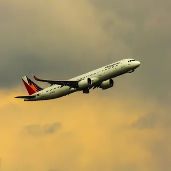 Philippine Airlines aircraft departing during sunset