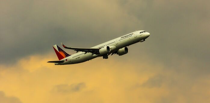 Philippine Airlines aircraft departing during sunset