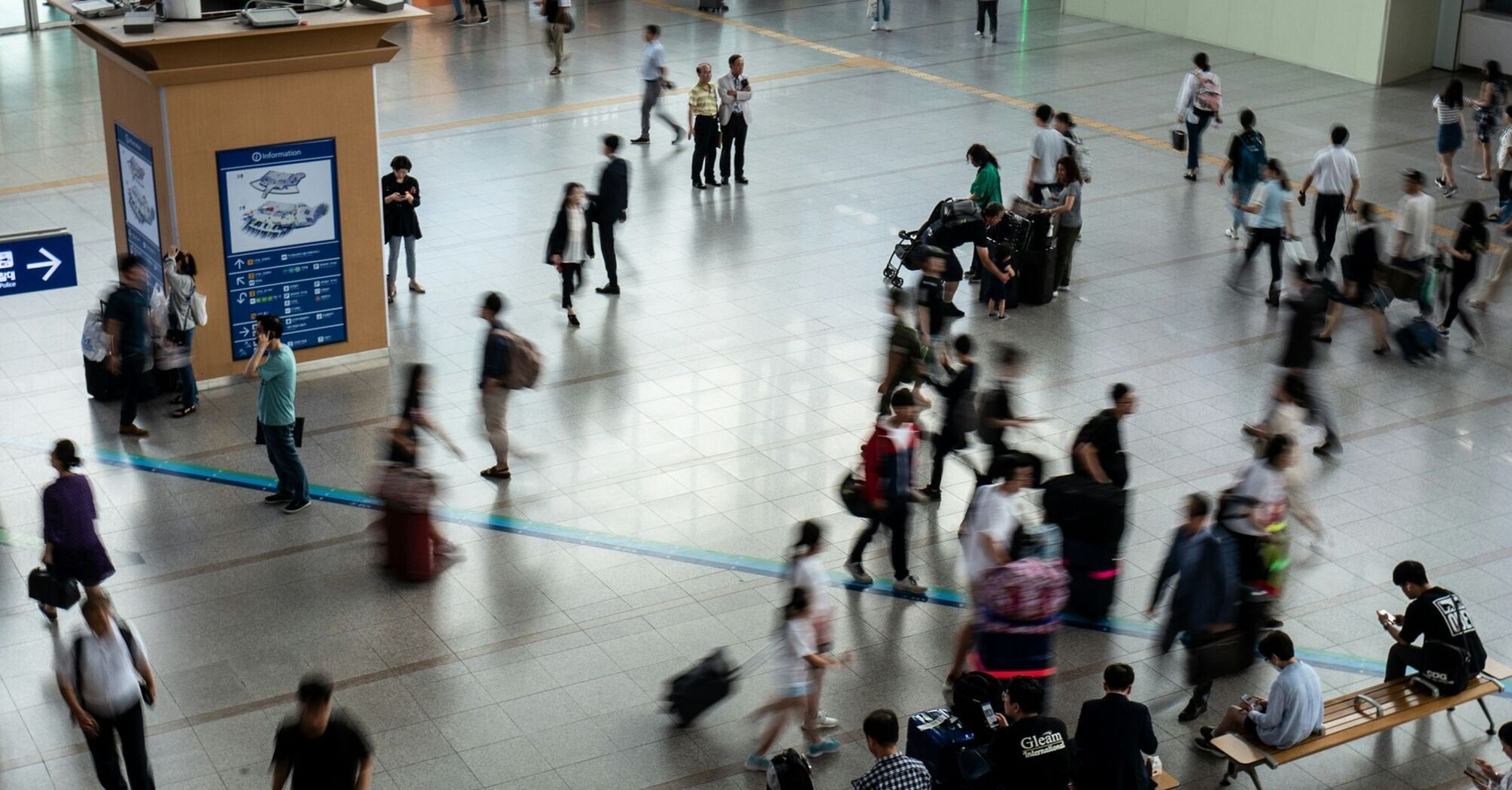 Busy airport terminal with passengers moving through departures hall