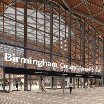 Main entrance of Birmingham Curzon Street Station with glass façade and public square