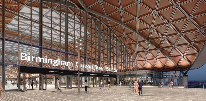 Main entrance of Birmingham Curzon Street Station with glass façade and public square