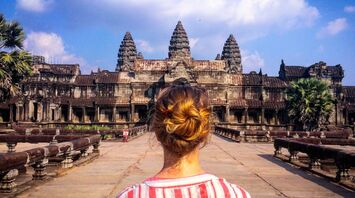 Woman looking at Angkor Wat temple in Asia