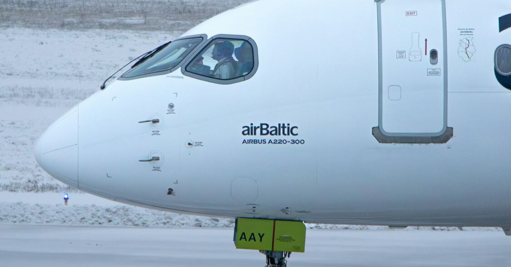 airBaltic Airbus A220-300 aircraft on snowy runway