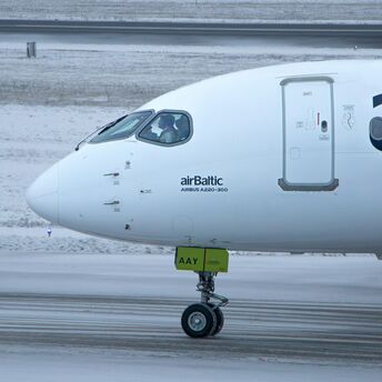 airBaltic Airbus A220-300 aircraft on snowy runway