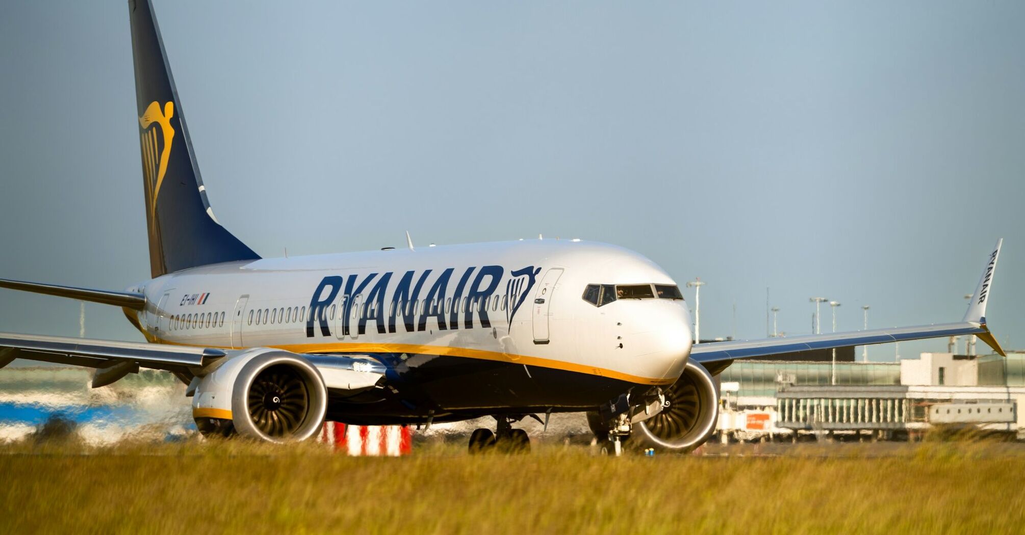 Ryanair aircraft on runway near airport buildings