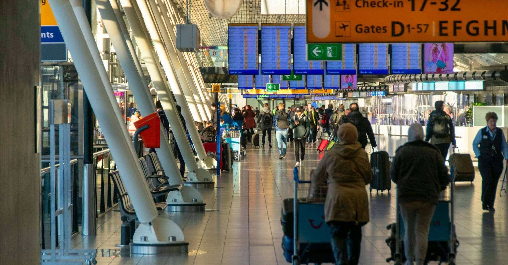 Busy airport terminal with passengers walking to departure gates