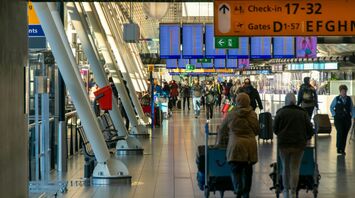 Busy airport terminal with passengers walking to departure gates