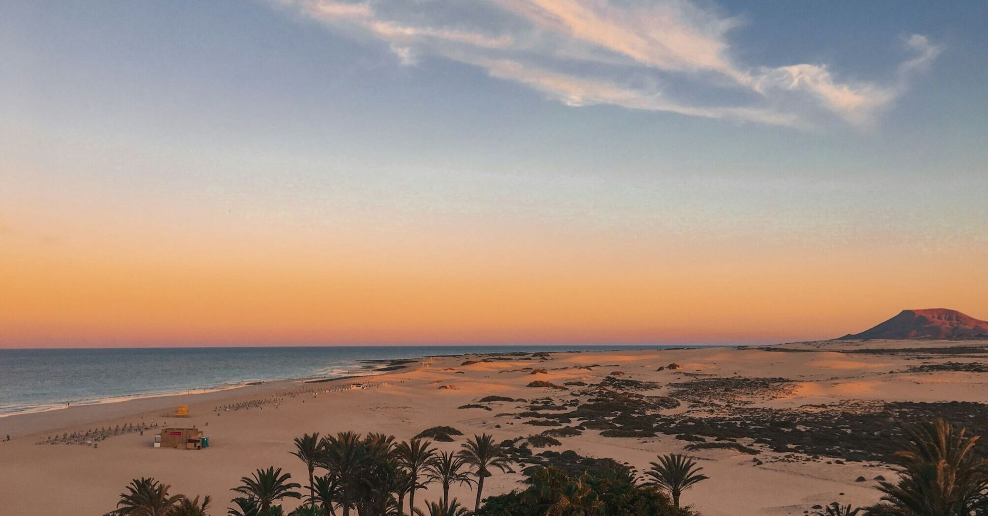Sand dunes and beach in Fuerteventura at sunset