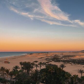 Sand dunes and beach in Fuerteventura at sunset