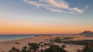 Sand dunes and beach in Fuerteventura at sunset