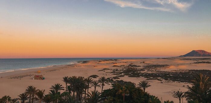 Sand dunes and beach in Fuerteventura at sunset