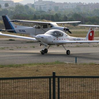 Small electric aircraft on airport runway