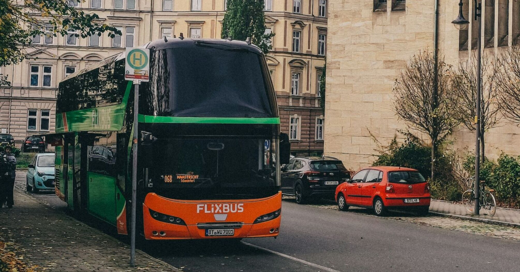FlixBus coach stopped on city street near bus stop