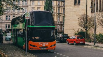FlixBus coach stopped on city street near bus stop