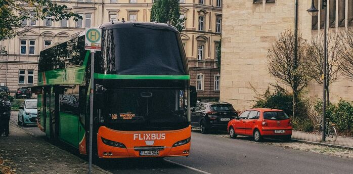 FlixBus coach stopped on city street near bus stop