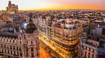 Evening skyline of central Barcelona with Gran Vía and Metropolis building