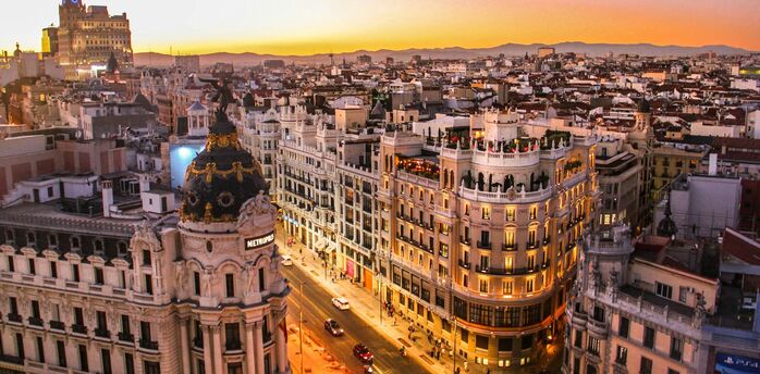 Evening skyline of central Barcelona with Gran Vía and Metropolis building