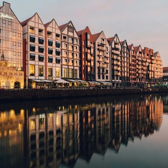 Riverside buildings in Gdańsk at sunset