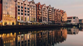 Riverside buildings in Gdańsk at sunset