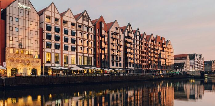 Riverside buildings in Gdańsk at sunset