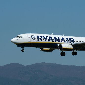 Ryanair aircraft in flight against blue sky