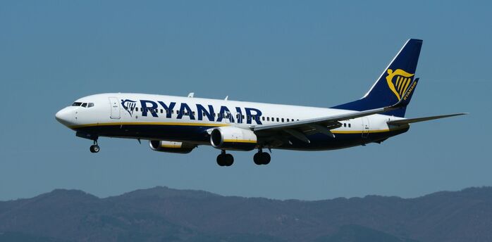 Ryanair aircraft in flight against blue sky
