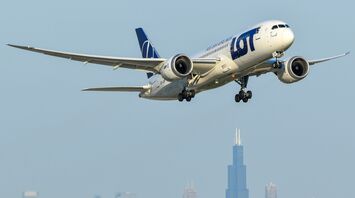 LOT Polish Airlines aircraft approaching city skyline