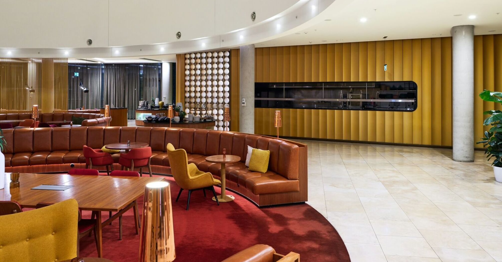 Interior of a lounge with seating and curved ceiling design