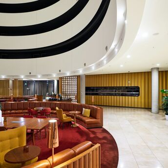 Interior of a lounge with seating and curved ceiling design
