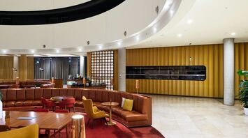 Interior of a lounge with seating and curved ceiling design