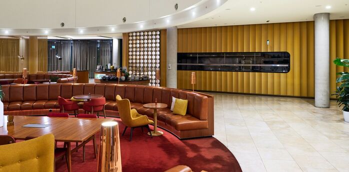 Interior of a lounge with seating and curved ceiling design