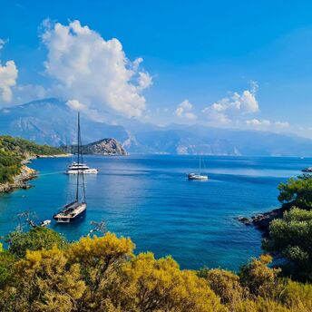 Sailboats anchored in a quiet turquoise bay on Turkey’s Mediterranean coast