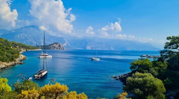 Sailboats anchored in a quiet turquoise bay on Turkey’s Mediterranean coast