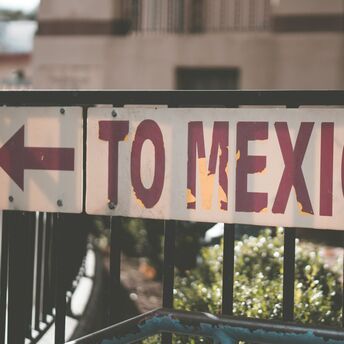 Street sign pointing toward Mexico direction